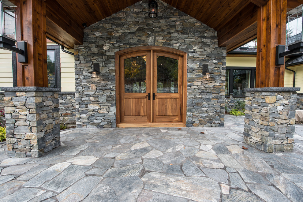 Photo of a large arts and crafts front door in Vancouver with a double front door and a light wood front door.