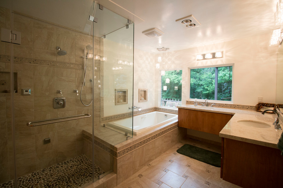 Design ideas for a mid-sized transitional master bathroom in Other with an undermount sink, flat-panel cabinets, light wood cabinets, solid surface benchtops, a drop-in tub, a double shower, a two-piece toilet, beige tile, ceramic tile, beige walls and ceramic floors.