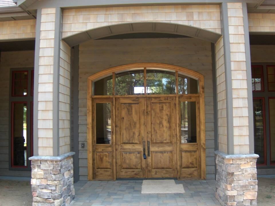 Large mountain style front door photo with a medium wood front door