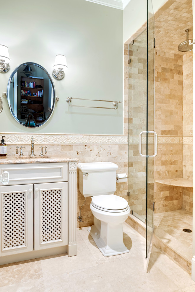 Mid-sized traditional 3/4 bathroom in Other with recessed-panel cabinets, white cabinets, an alcove shower, a two-piece toilet, brown tile, stone tile, green walls, travertine floors, an undermount sink, granite benchtops, beige floor, a hinged shower door and brown benchtops.