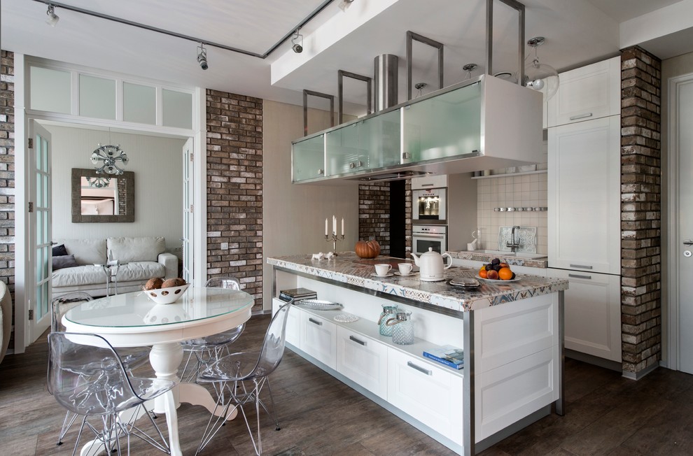 This is an example of a mid-sized industrial galley open plan kitchen in Moscow with recessed-panel cabinets, white cabinets, tile benchtops, white splashback, ceramic splashback, white appliances, porcelain floors, with island and a double-bowl sink.