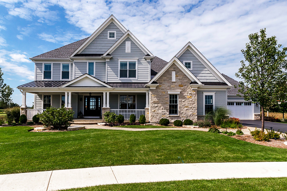 Large transitional two-storey grey house exterior in Chicago with mixed siding, a clipped gable roof and a shingle roof.