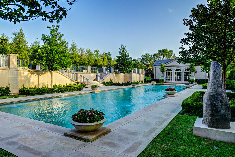 This is an example of a traditional rectangular pool in Dallas with a water feature.