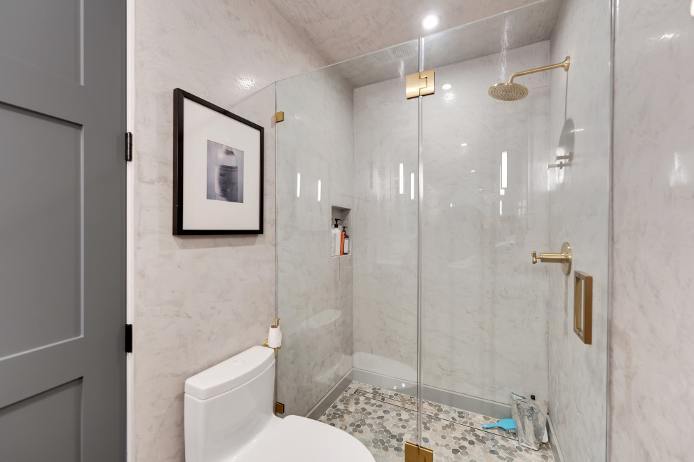 Mid-sized minimalist kids' single-sink, ceramic tile and gray floor corner shower photo in Los Angeles with a floating vanity, flat-panel cabinets, medium tone wood cabinets, a one-piece toilet, gray walls, a console sink, quartzite countertops, a hinged shower door, multicolored countertops and a niche