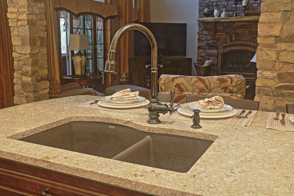 Eat-in kitchen - large transitional l-shaped light wood floor eat-in kitchen idea with an undermount sink, raised-panel cabinets, brown cabinets, quartz countertops, beige backsplash, ceramic backsplash, stainless steel appliances and an island