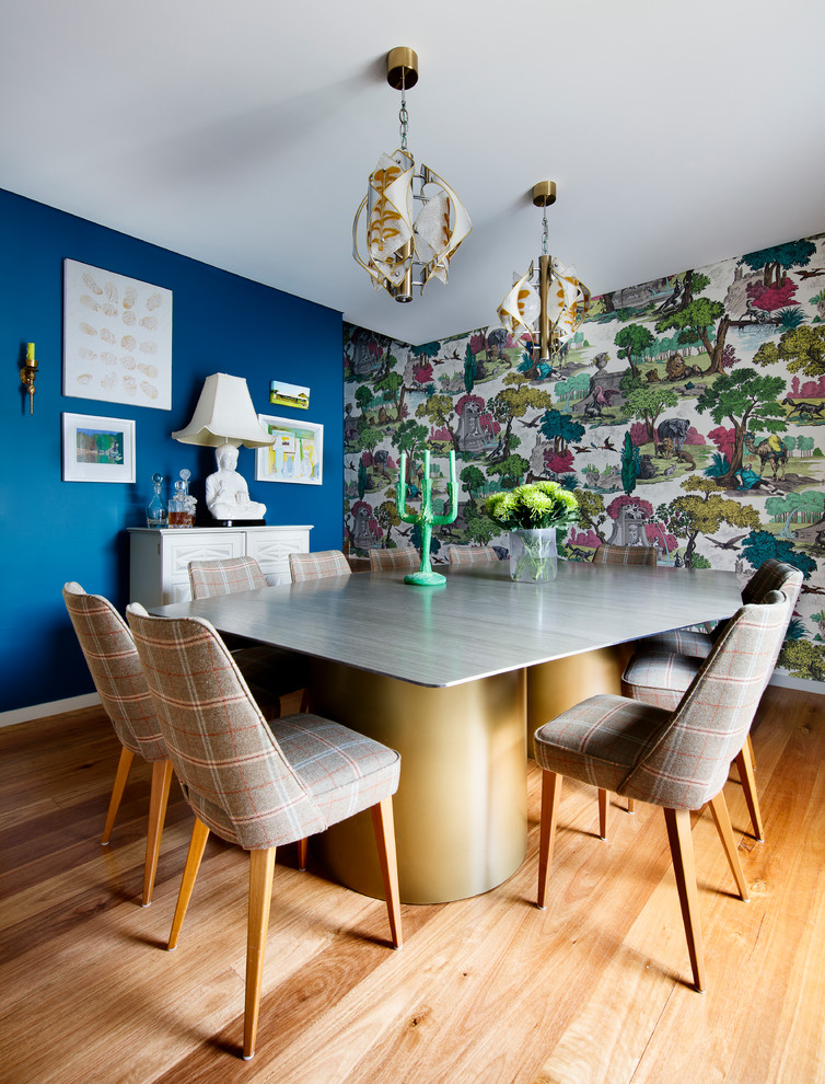 Design ideas for a dining room in Sydney with blue walls, medium hardwood floors and brown floor.