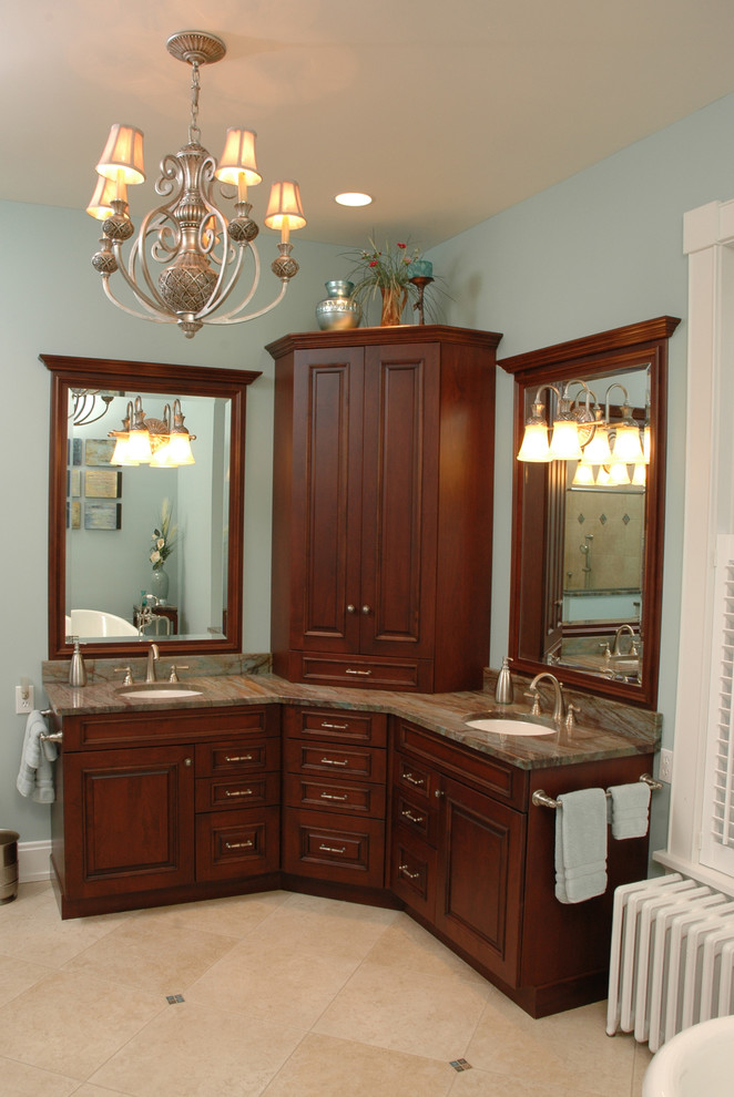 Inspiration for a mid-sized traditional master bathroom in Cincinnati with an undermount sink, raised-panel cabinets, dark wood cabinets, granite benchtops, blue walls and travertine floors.