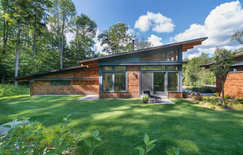 Contemporary one-storey exterior in Burlington with wood siding and a shed roof.