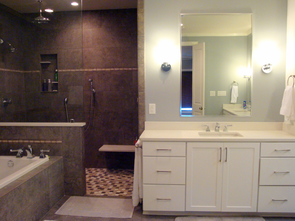 Design ideas for a large contemporary master bathroom in Jackson with shaker cabinets, white cabinets, a drop-in tub, a curbless shower, a two-piece toilet, brown tile, ceramic tile, blue walls and ceramic floors.