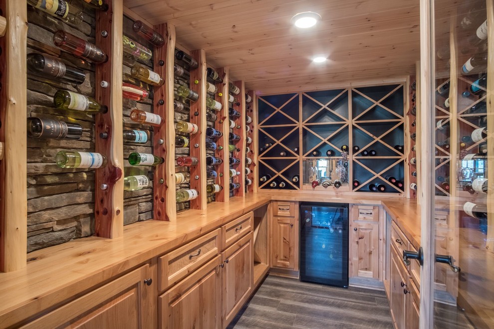 Photo of a country wine cellar in Birmingham with diamond bins and brown floor.