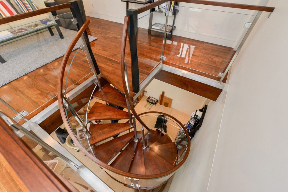 Design ideas for a small modern wood spiral staircase in San Francisco with open risers.