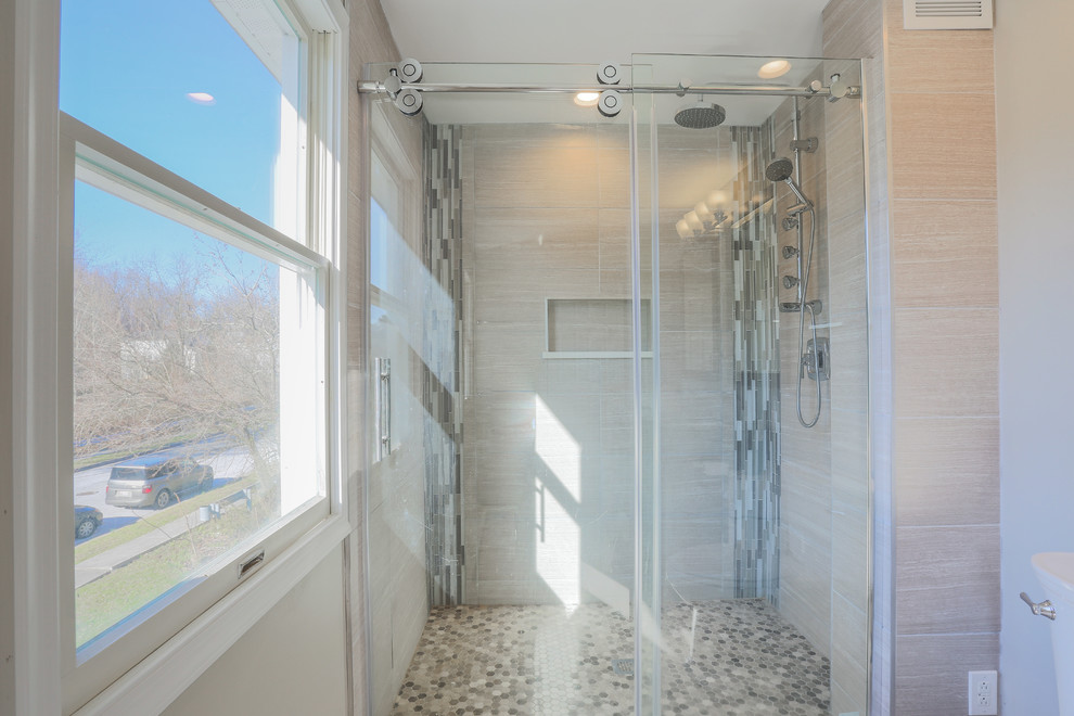 This is an example of a mid-sized transitional master bathroom in Baltimore with furniture-like cabinets, dark wood cabinets, an alcove shower, a two-piece toilet, beige walls, porcelain floors, an undermount sink, granite benchtops, beige floor and a sliding shower screen.