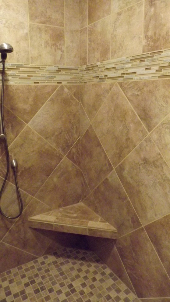 Transitional beige tile and porcelain tile porcelain tile doorless shower photo with an undermount sink, raised-panel cabinets, medium tone wood cabinets, granite countertops and beige walls