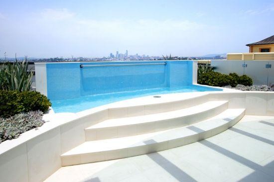 Design ideas for a large modern backyard patio in Brisbane with a water feature.
