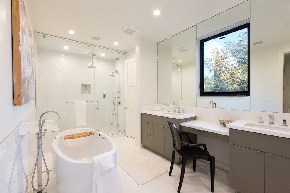 Photo of a large modern master bathroom in Los Angeles with flat-panel cabinets, grey cabinets, a freestanding tub, an alcove shower, a one-piece toilet, white tile, porcelain tile, white walls, porcelain floors, an undermount sink, quartzite benchtops, white floor and a hinged shower door.
