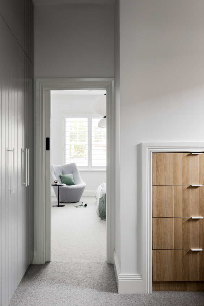 Contemporary storage and wardrobe in Melbourne with flat-panel cabinets, light wood cabinets, carpet and grey floor.