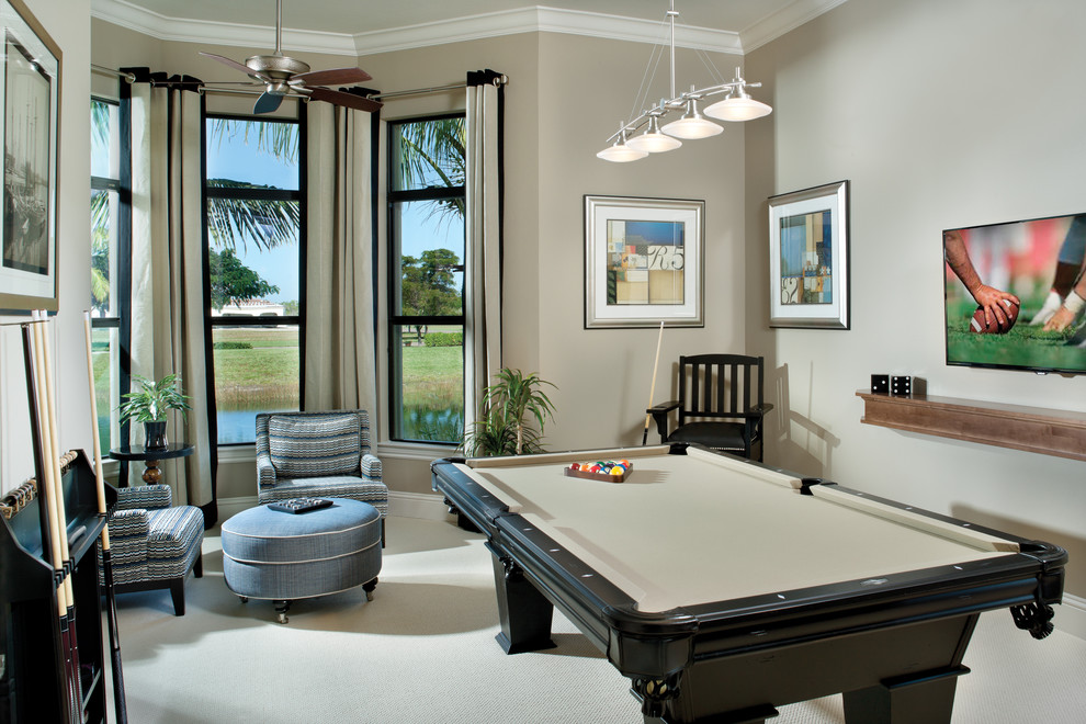 Photo of a mediterranean enclosed family room in Tampa with beige walls and carpet.