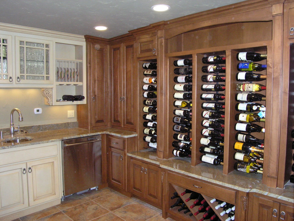 Inspiration for a mid-sized traditional u-shaped home bar in Other with an undermount sink, raised-panel cabinets, medium wood cabinets, granite benchtops and brown floor.
