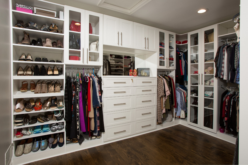 This is an example of a small traditional women's dressing room in DC Metro with recessed-panel cabinets, white cabinets, dark hardwood floors and brown floor.