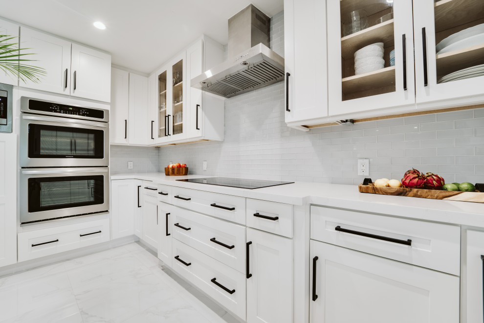 Design ideas for a large modern u-shaped eat-in kitchen in Miami with an undermount sink, shaker cabinets, white cabinets, grey splashback, glass tile splashback, stainless steel appliances, ceramic floors, with island, grey floor and white benchtop.