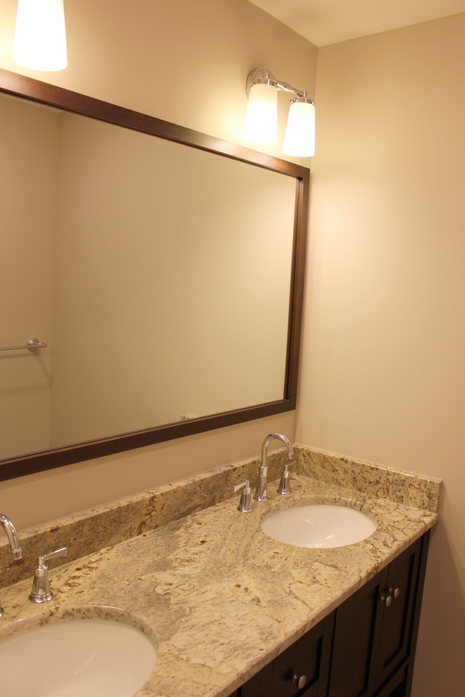 Inspiration for a transitional bathroom remodel in Cincinnati with recessed-panel cabinets, dark wood cabinets and granite countertops