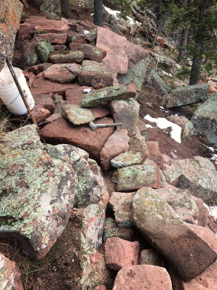 Photo of a huge rustic hillside retaining wall landscape in Denver.