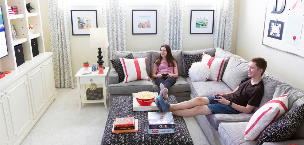 The Davis Home - Game room for teens, kids family-friendly, gray sectional, wall color Benjamin Moore Soft Chamois, Custom Ottoman black and white, red, black, white, and gray color scheme. Custom Bookcases, Fine Art Photography, Custom Barn Door for closet.