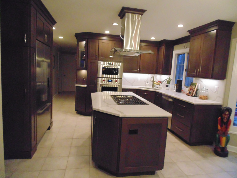 Mid-sized transitional u-shaped ceramic tile and beige floor eat-in kitchen photo with an undermount sink, recessed-panel cabinets, dark wood cabinets, quartz countertops, white backsplash, stone slab backsplash, stainless steel appliances, an island and white countertops