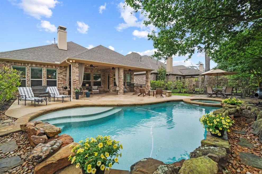 Inspiration for a small timeless backyard stone and custom-shaped lap hot tub remodel in Houston