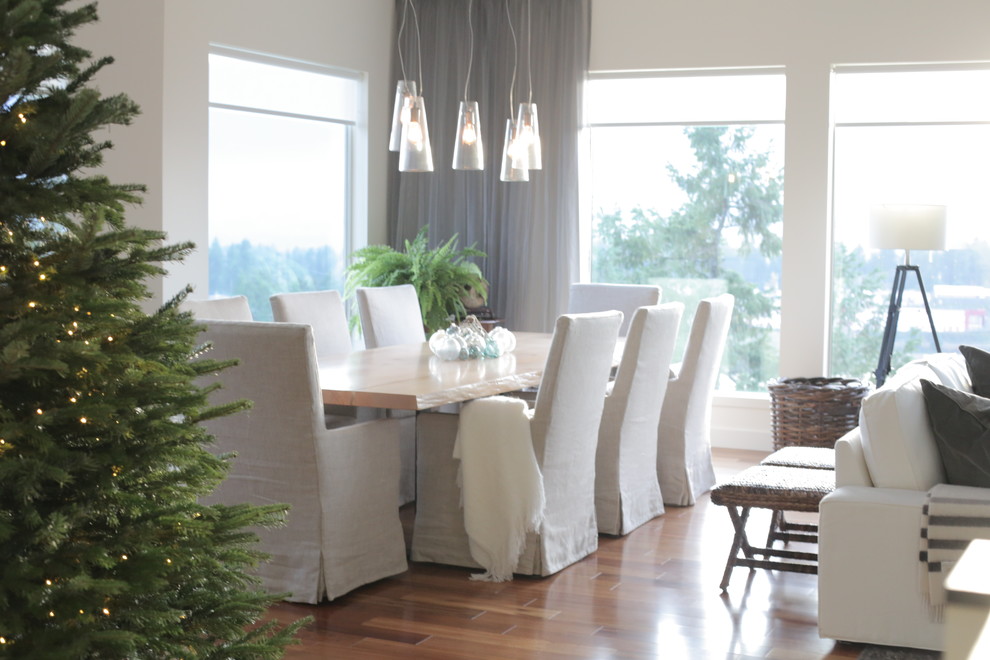 Photo of a traditional dining room in Vancouver with white walls and dark hardwood floors.