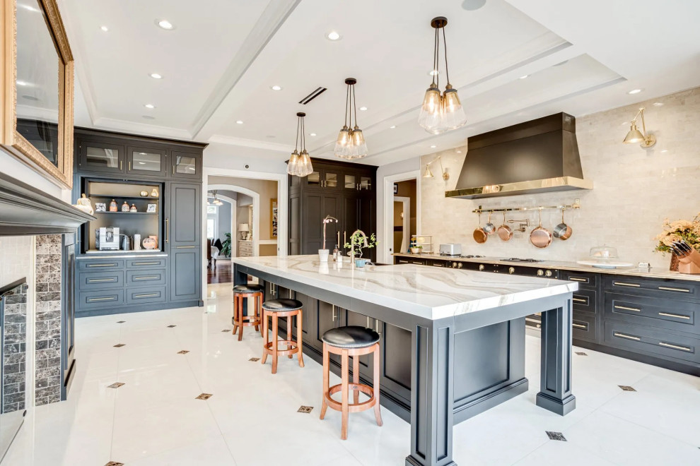Inspiration for a transitional u-shaped beige floor and tray ceiling kitchen remodel in Baltimore with black cabinets, beige backsplash, an island, beige countertops, a farmhouse sink, shaker cabinets, stone slab backsplash and black appliances