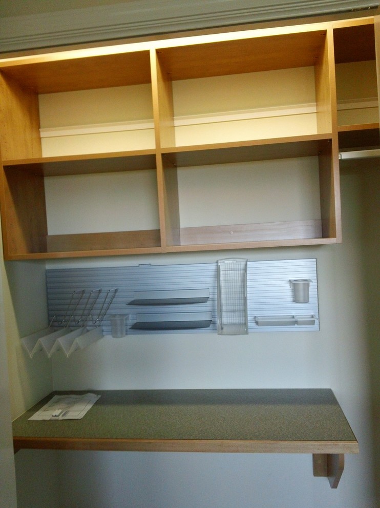 This is an example of a mid-sized contemporary gender-neutral walk-in wardrobe in Other with flat-panel cabinets, white cabinets and carpet.