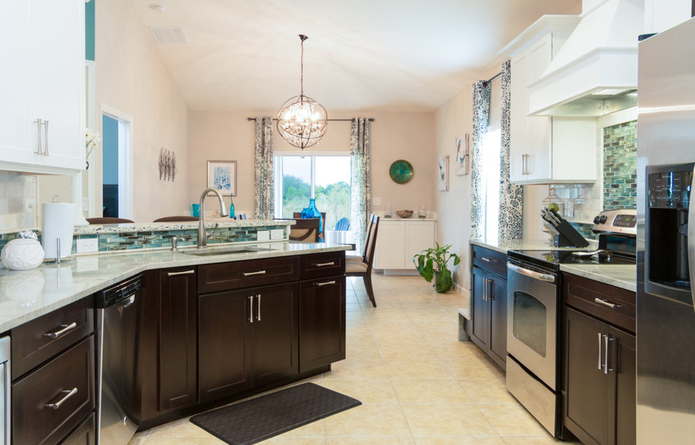 Small transitional galley ceramic tile and beige floor eat-in kitchen photo in Orlando with shaker cabinets, quartzite countertops, gray backsplash, stone tile backsplash, stainless steel appliances, white cabinets, a peninsula and an undermount sink