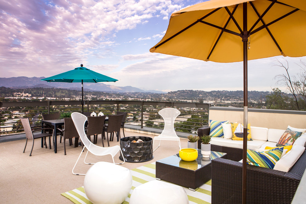 This is an example of a mid-sized contemporary rooftop deck in Los Angeles with a fire feature and no cover.