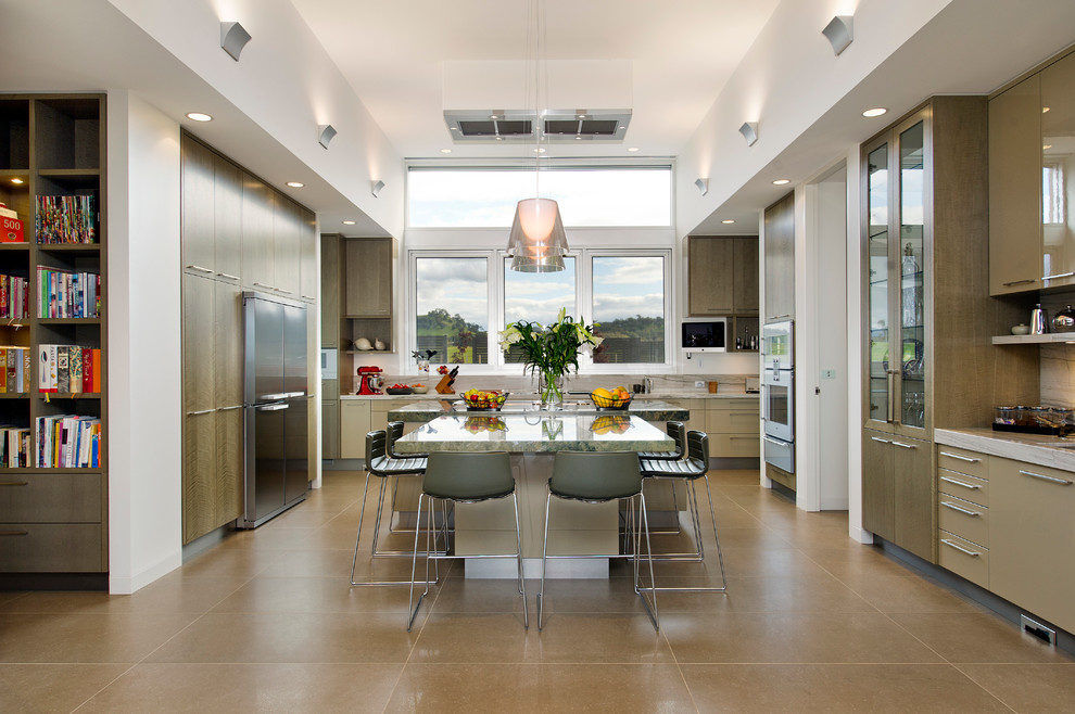 Inspiration for a contemporary u-shaped kitchen in Melbourne with a double-bowl sink, light wood cabinets, stainless steel appliances, porcelain floors, multiple islands, travertine splashback and marble benchtops.
