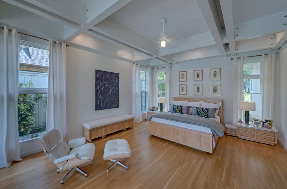 This is an example of a mid-sized modern master bedroom in Dallas with white walls, light hardwood floors and no fireplace.