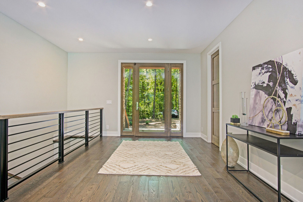 Inspiration for a rustic dark wood floor and brown floor foyer remodel in Grand Rapids with a glass front door