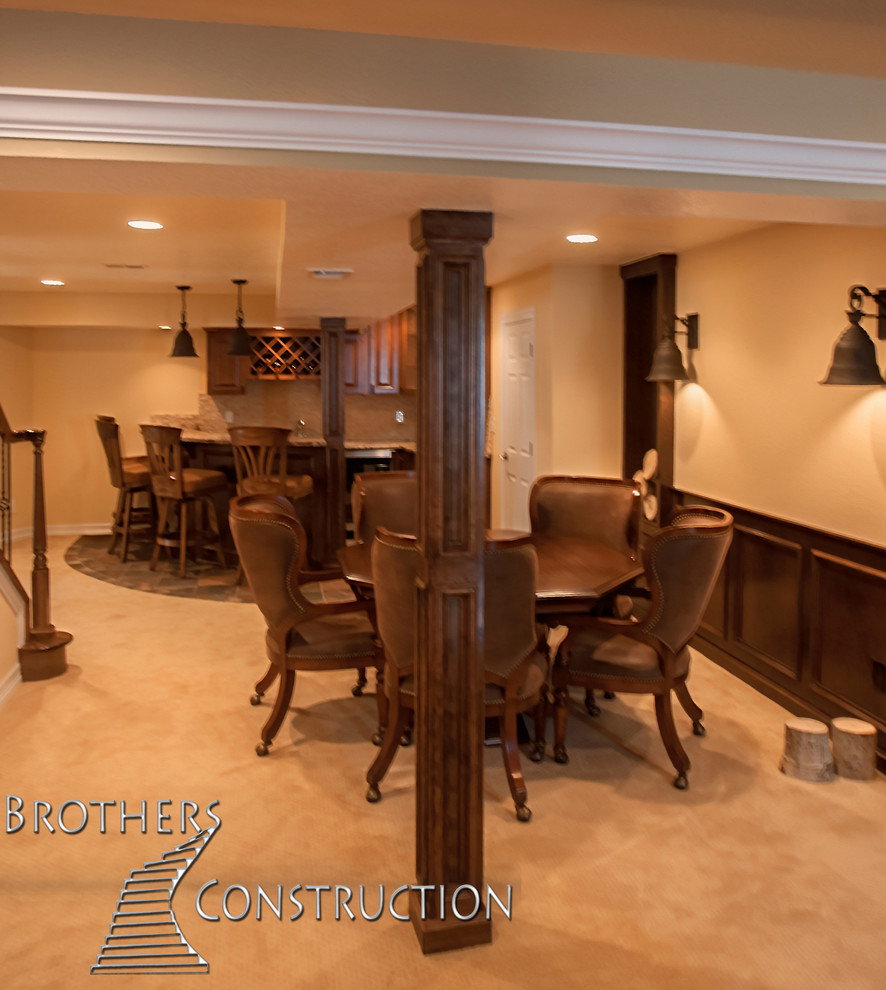 Photo of a mid-sized traditional fully buried basement in Denver with beige walls, carpet, a standard fireplace and a stone fireplace surround.
