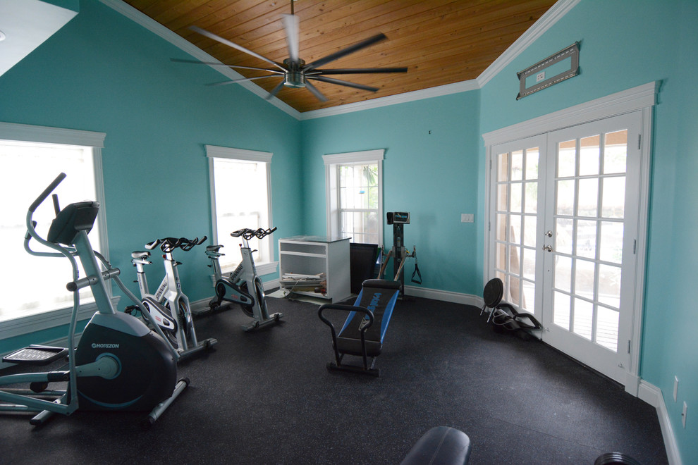 Photo of a large transitional multipurpose gym in Miami with blue walls and black floor.