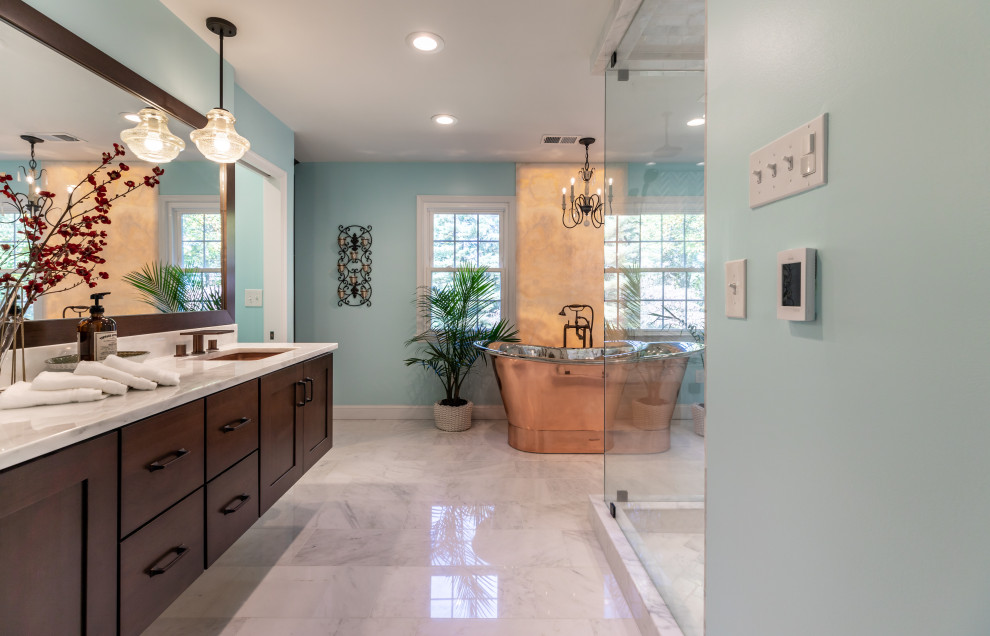 Small trendy master marble floor, gray floor and double-sink bathroom photo in DC Metro with dark wood cabinets, a one-piece toilet, blue walls, marble countertops, a hinged shower door, white countertops and a floating vanity