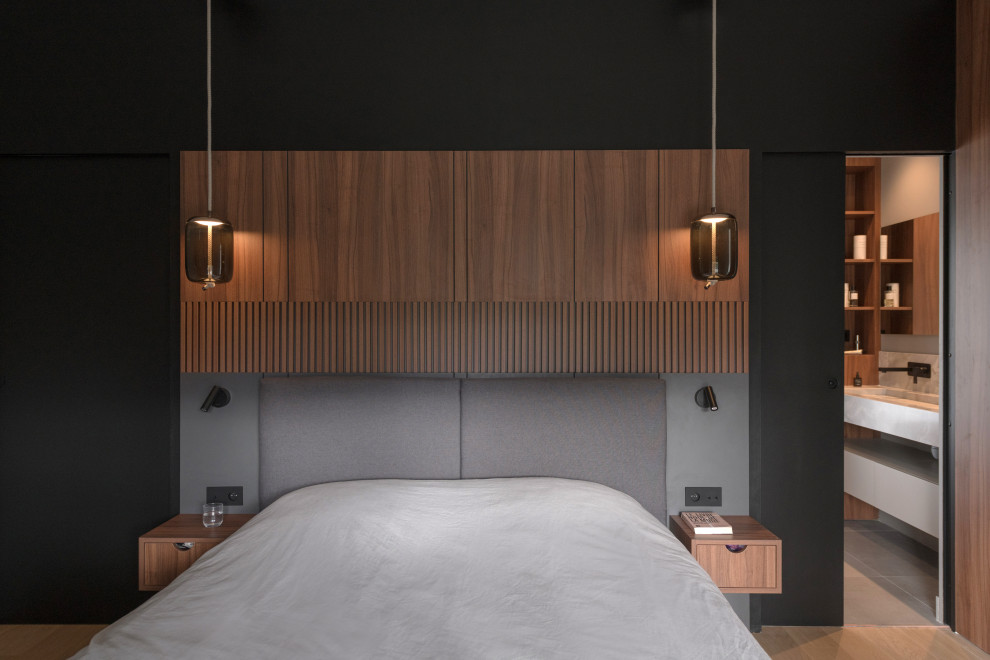 На фото: большая хозяйская спальня в современном стиле с черными стенами и светлым паркетным полом