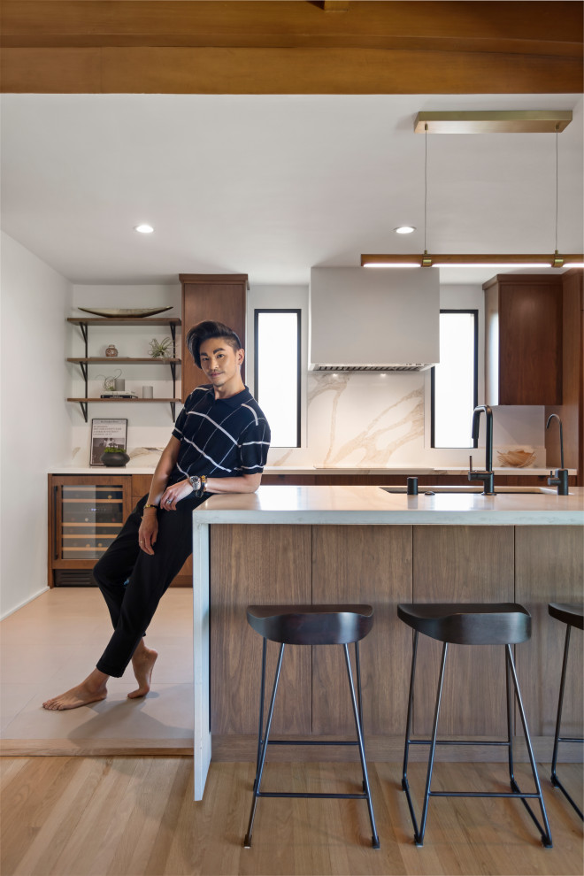 Design ideas for a mid-sized contemporary galley kitchen in Los Angeles with an undermount sink, flat-panel cabinets, medium wood cabinets, concrete benchtops, engineered quartz splashback, panelled appliances, porcelain floors, with island, grey floor and grey benchtop.