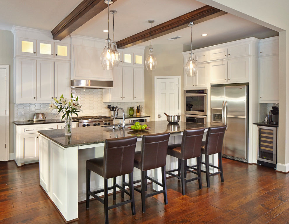 Design ideas for a traditional eat-in kitchen in Dallas with white cabinets, an undermount sink, shaker cabinets and stainless steel appliances.