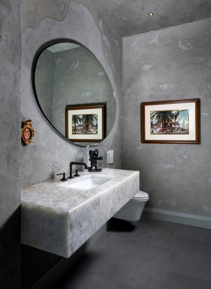 Photo of a small contemporary powder room in Tampa with a one-piece toilet, grey walls, a drop-in sink, engineered quartz benchtops, grey floor and white benchtops.