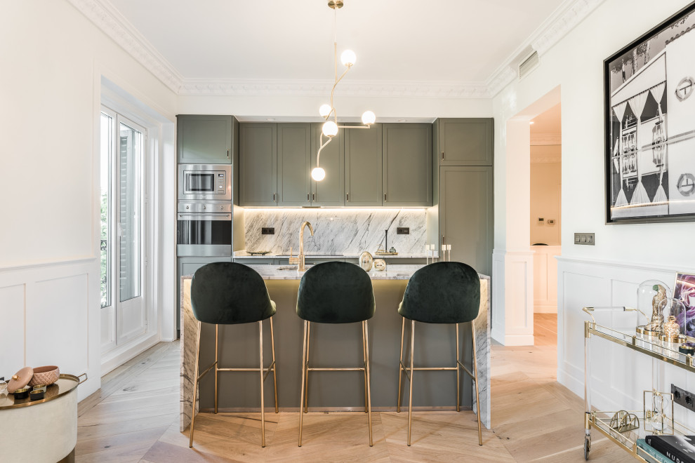 Design ideas for a scandinavian galley separate kitchen in Madrid with an undermount sink, shaker cabinets, green cabinets, grey splashback, stone slab splashback, stainless steel appliances, light hardwood floors, with island, beige floor and grey benchtop.