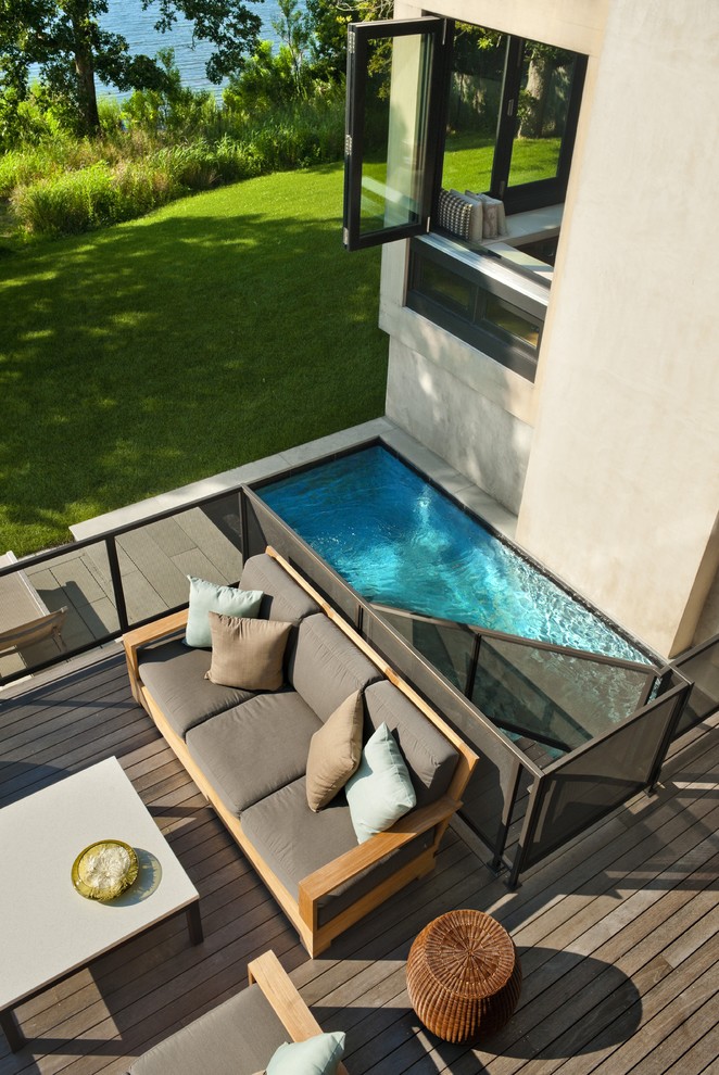 This is an example of a beach style backyard deck in New York.