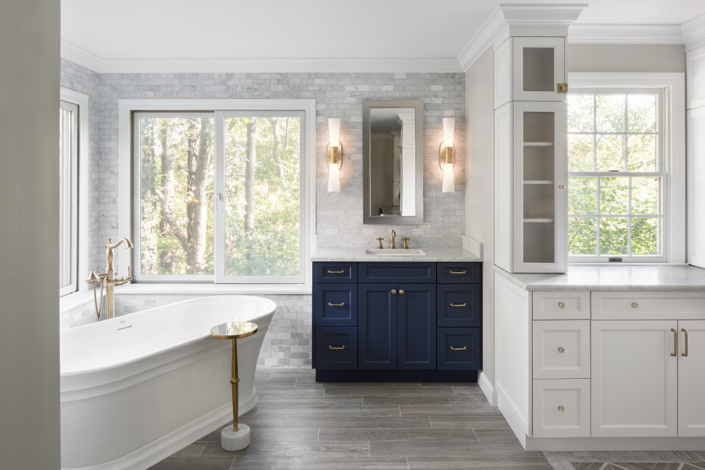 Inspiration for a bathroom in St Louis with flat-panel cabinets, blue cabinets, a freestanding tub, yellow tile, marble, wood-look tile, an undermount sink, marble benchtops, grey floor, yellow benchtops, a single vanity and a built-in vanity.