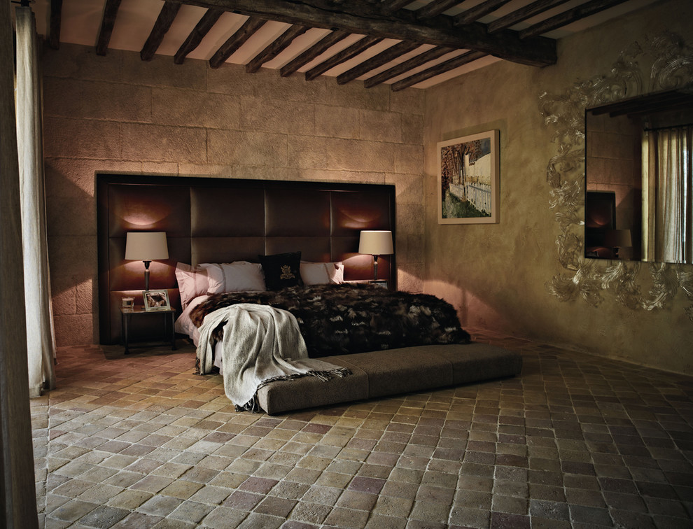 Mediterranean bedroom in Other with terra-cotta floors.