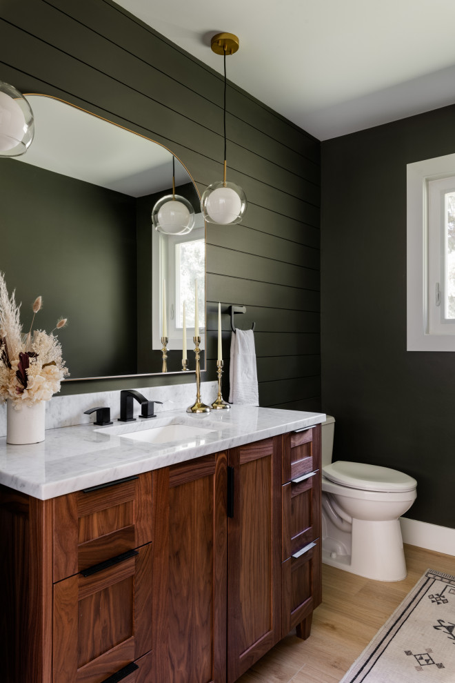 This is an example of a medium sized rural cloakroom in Vancouver with shaker cabinets, dark wood cabinets, a two-piece toilet, green walls, vinyl flooring, a submerged sink, marble worktops, beige floors, grey worktops, a freestanding vanity unit and tongue and groove walls.