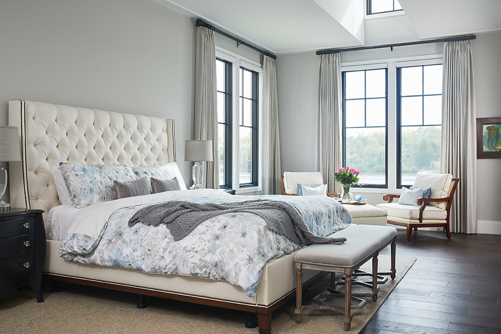 Inspiration for a transitional master bedroom in Grand Rapids with grey walls, dark hardwood floors, brown floor and a standard fireplace.
